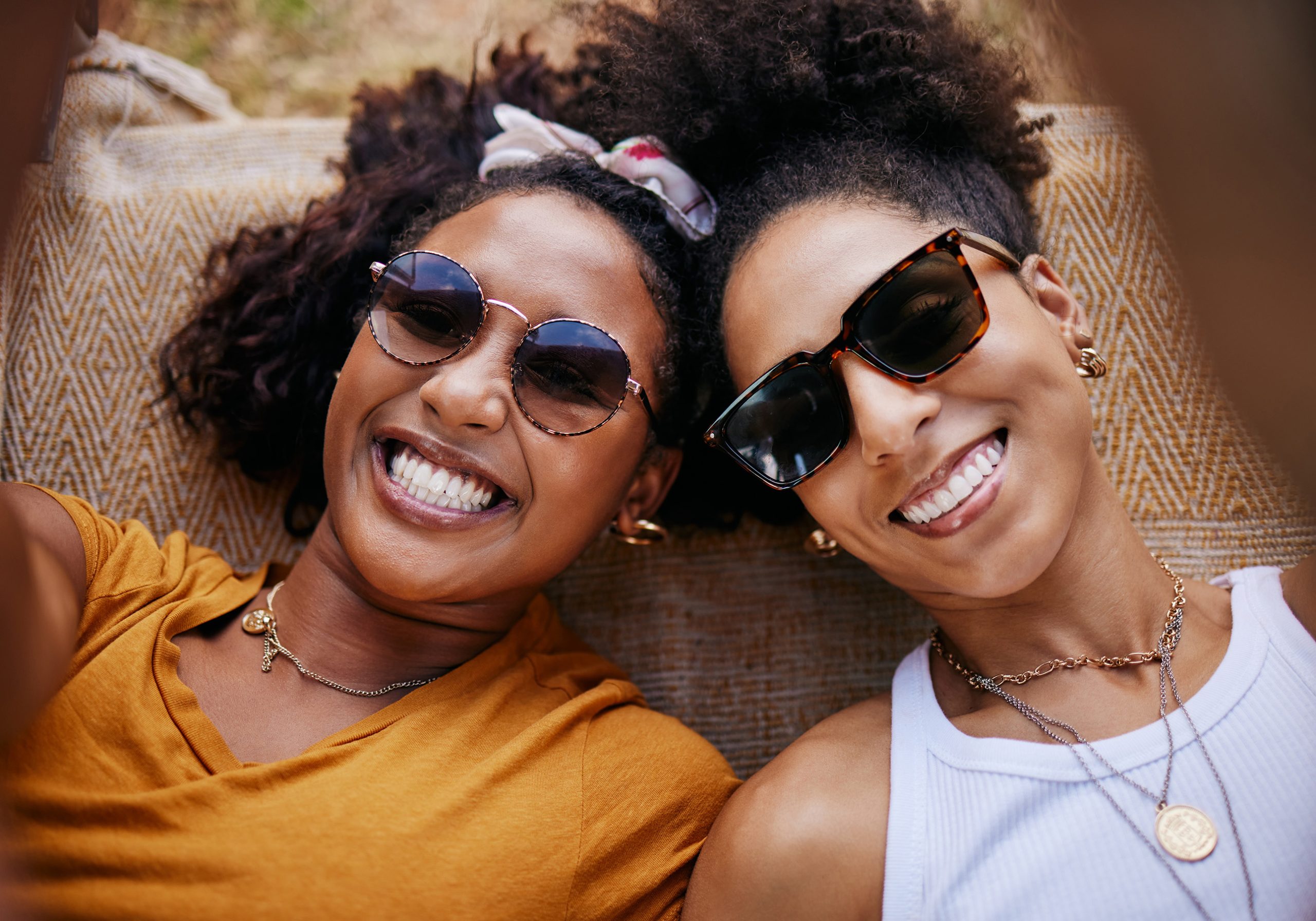 two friends wearing sunglasses smiling in Parker, CO